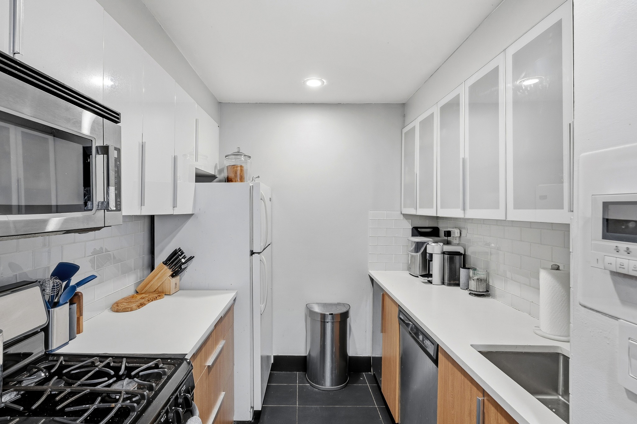 179 Grand Street, Unit 2F Manhattan, NY 10013 - Photo 3 of 11 a kitchen with a sink a stove and refrigerator