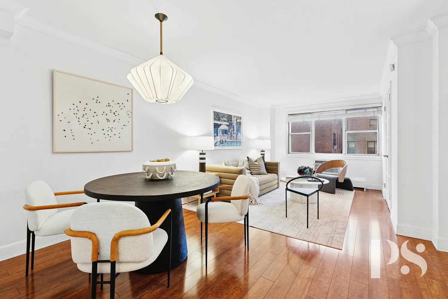 a view of a dining room with furniture wooden floor and chandelier