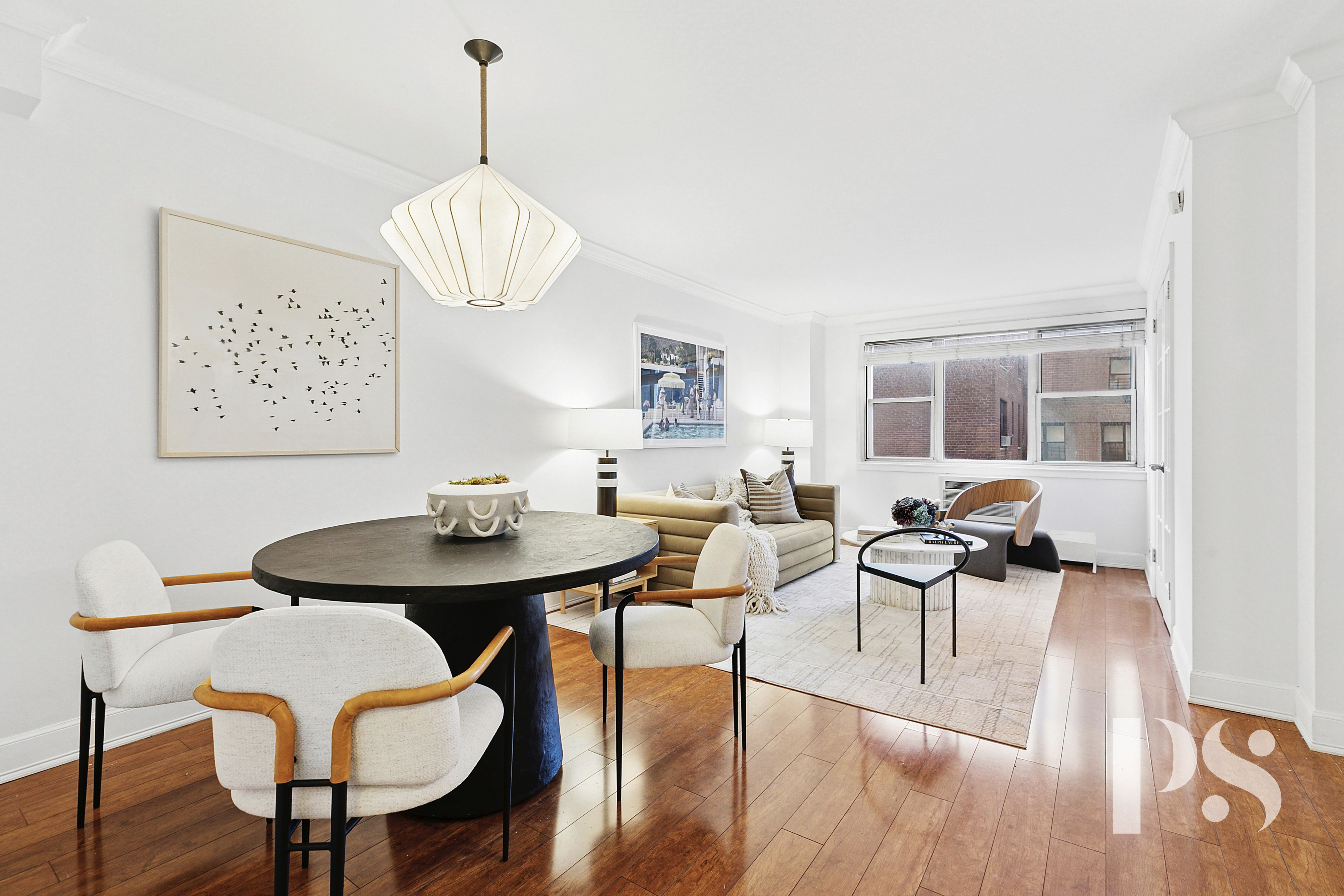 a view of a dining room with furniture wooden floor and chandelier