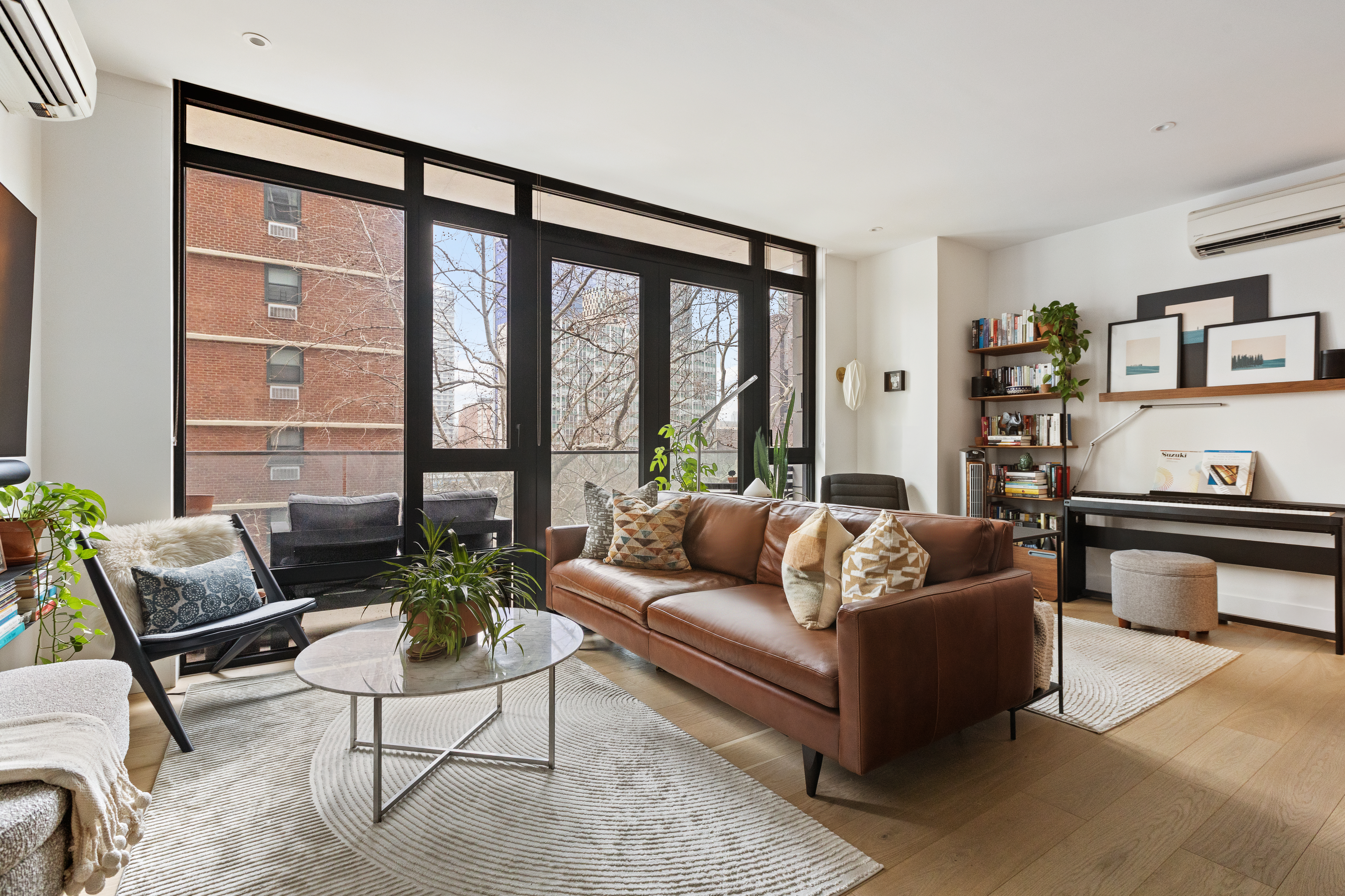 112 Fleet Place, Unit 6A Brooklyn, NY 11201 - Photo 2 of 11 a living room with furniture and a large window