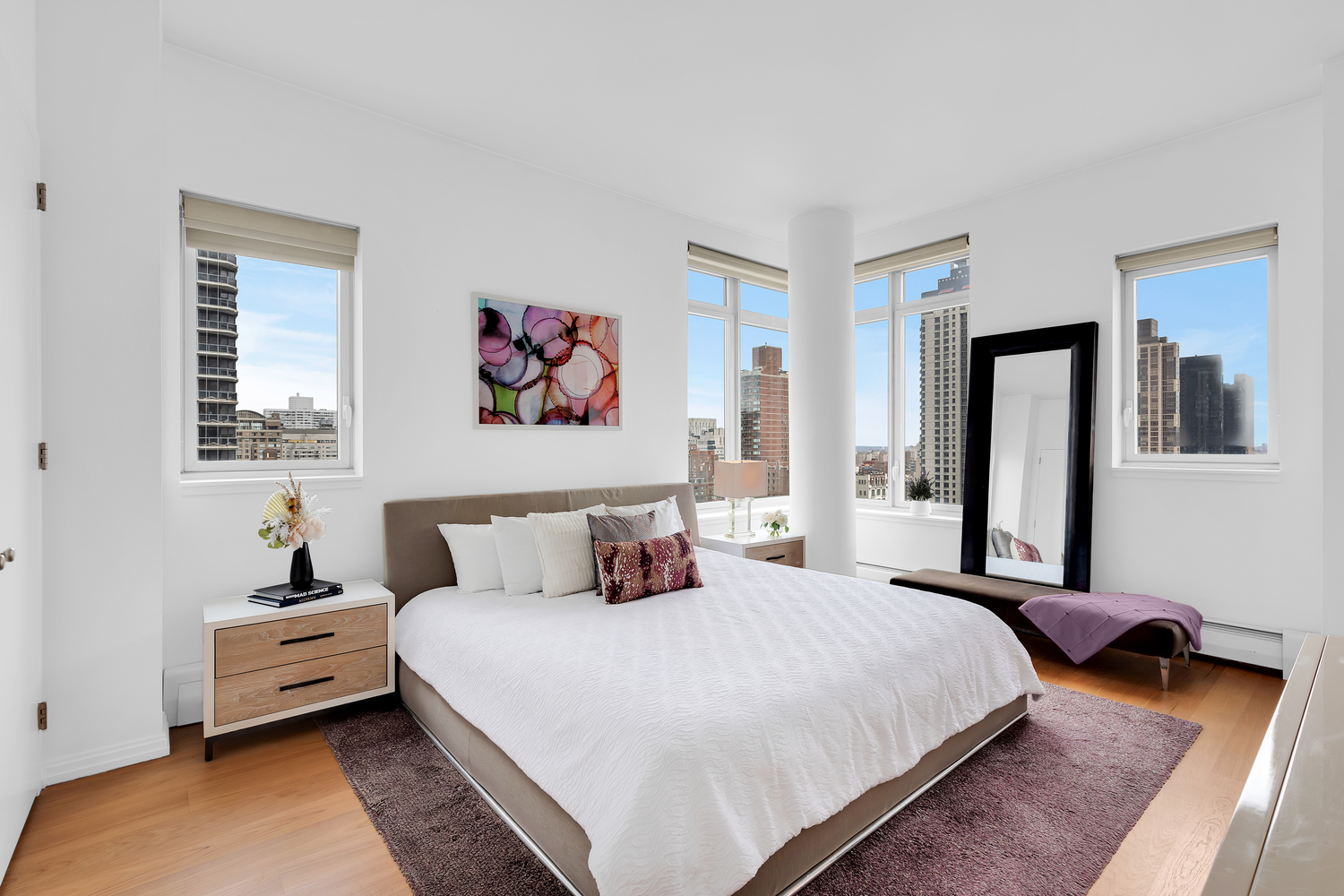 205 East 59th Street, Unit 19A Manhattan, NY 10022 - Photo 6 of 14 a bedroom with a bed and a couch