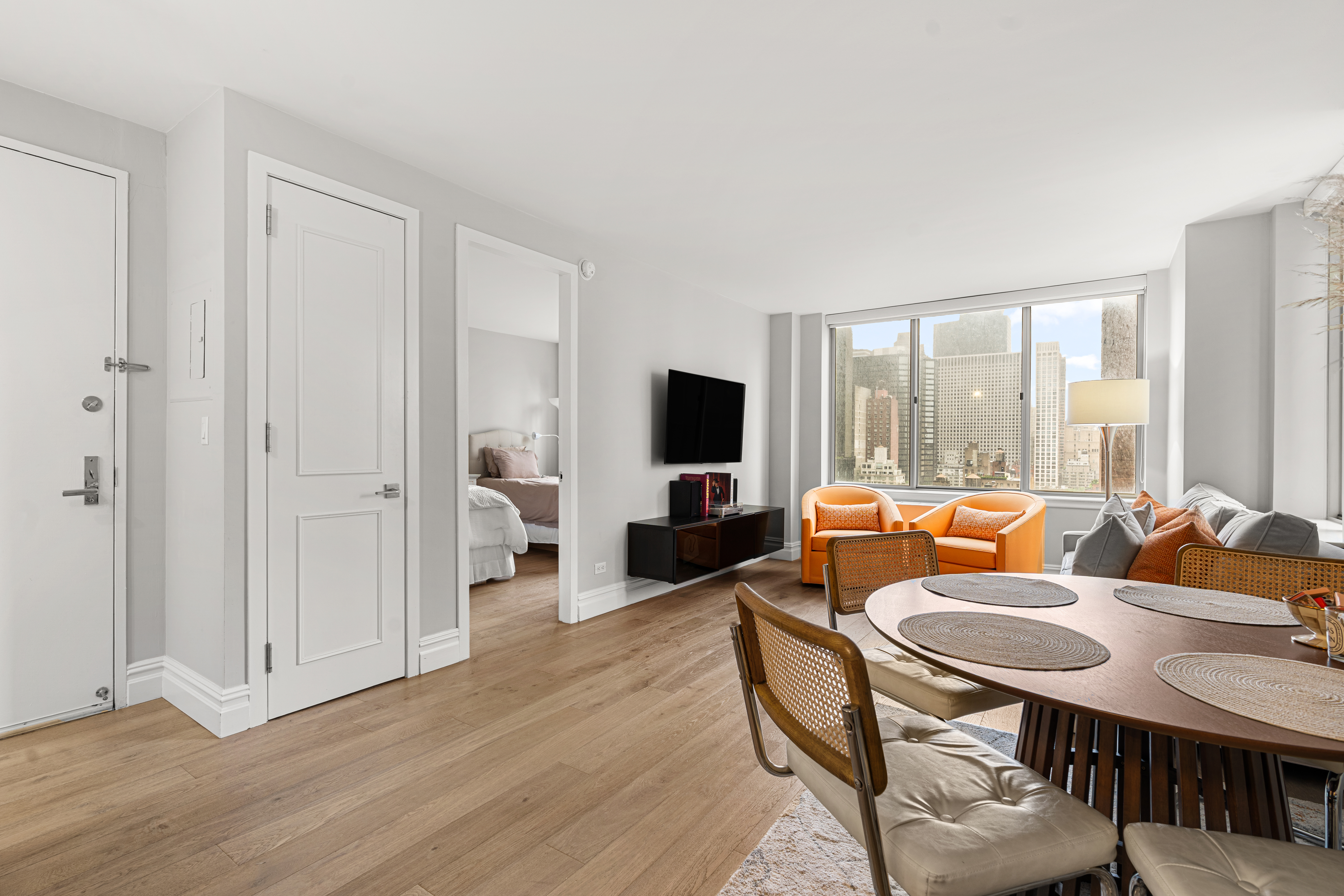 236 East 47th Street, Unit 17C Manhattan, NY 10017 - Photo 5 of 11 a living room with furniture and a flat screen tv