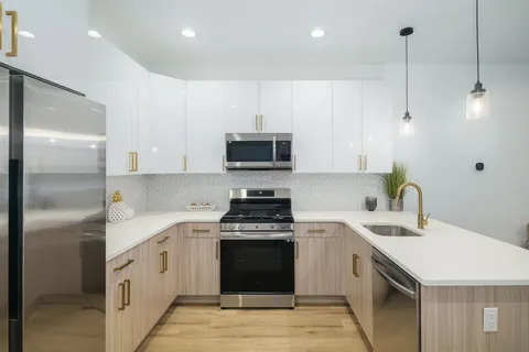 a kitchen with a sink stove and refrigerator