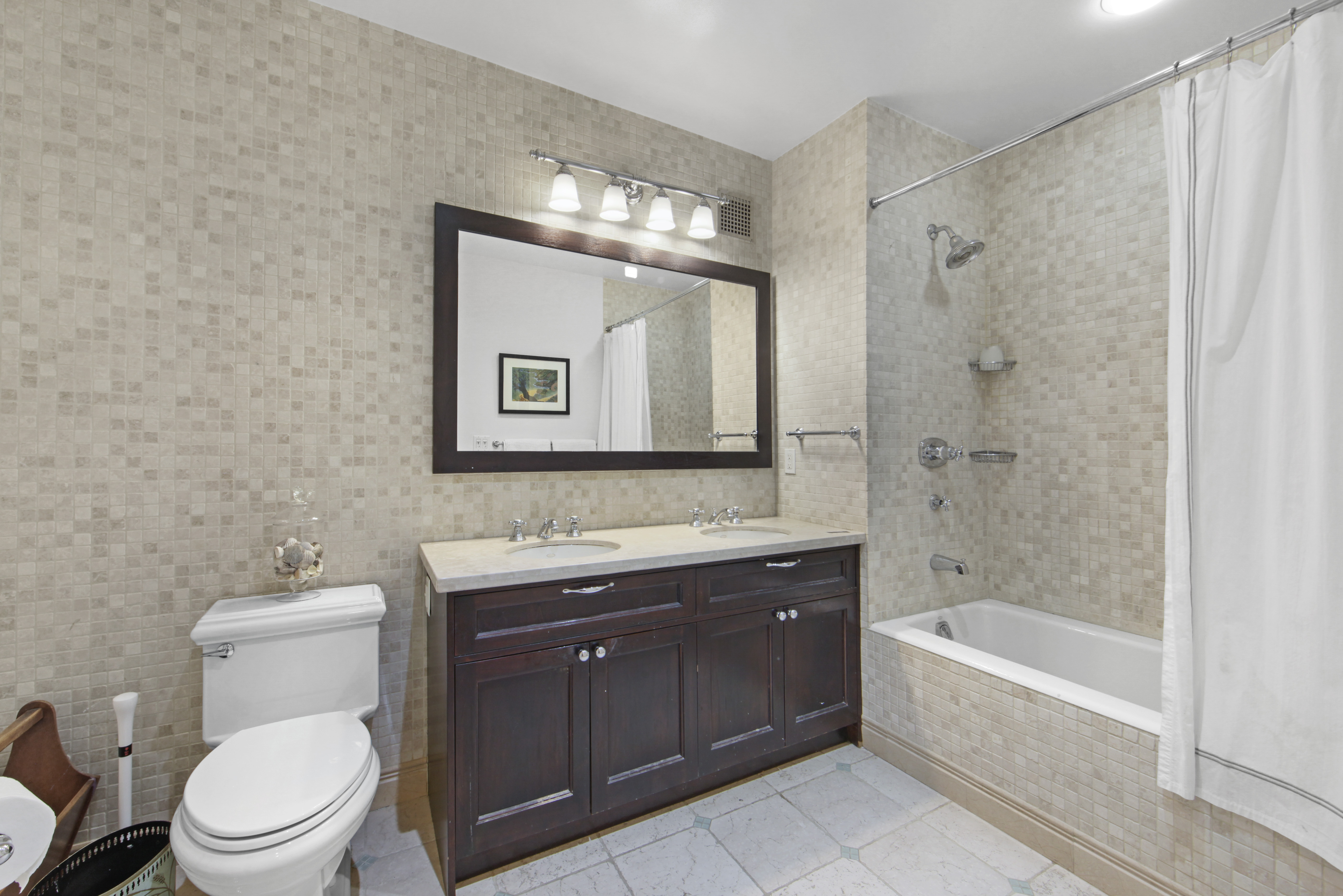 18 East 12th Street, Unit 7BC Manhattan, NY 10003 - Photo 20 of 26 a bathroom with a toilet a sink a mirror a bathtub and shower