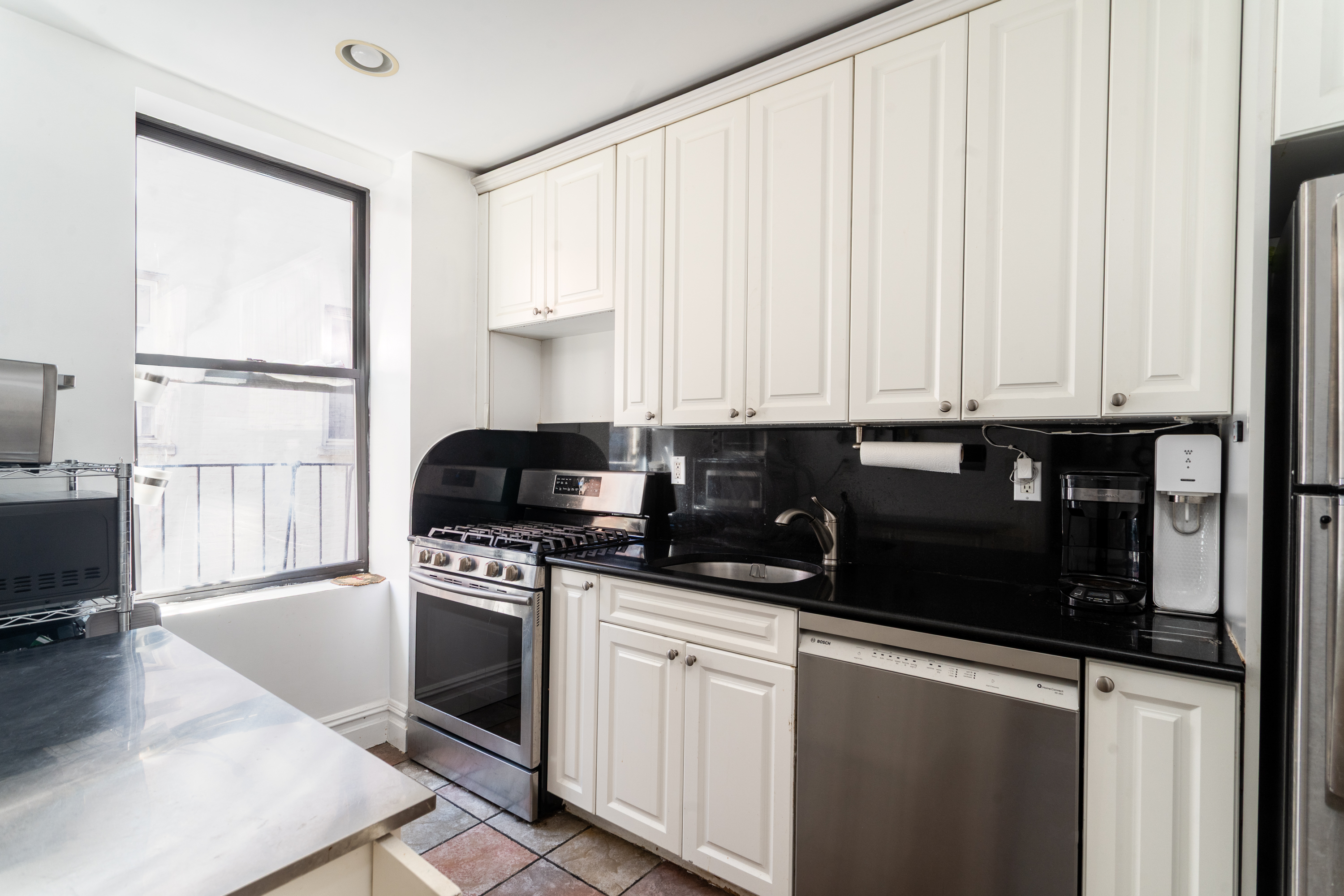 750 Riverside Drive, Unit 4E Manhattan, NY 10031 - Photo 4 of 11 a kitchen with granite countertop a stove a sink and a granite counter tops