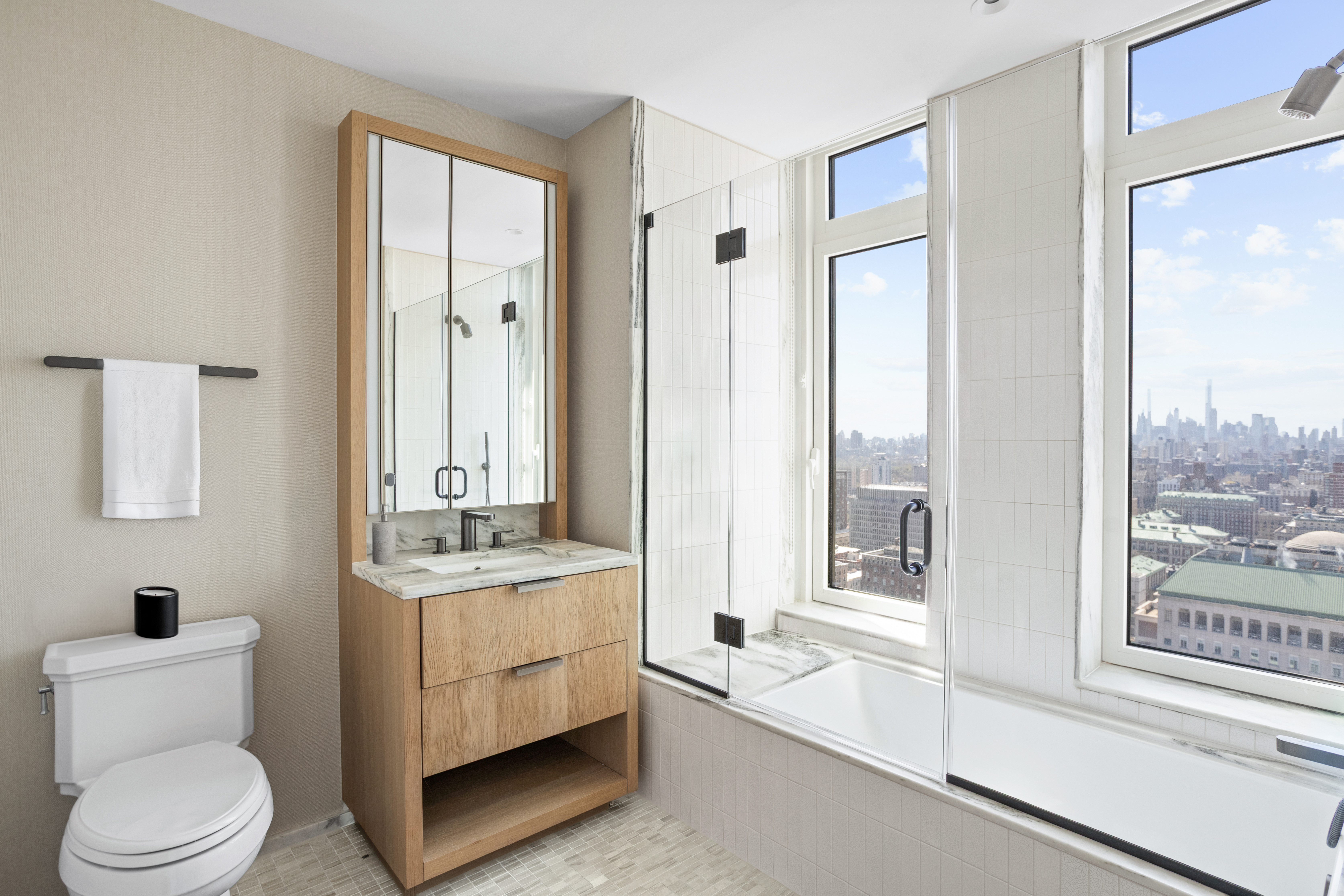 543 West 122nd Street, Unit PH31A Manhattan, NY 10027 - Photo 27 of 40 a bathroom with a sink a toilet and a large mirror