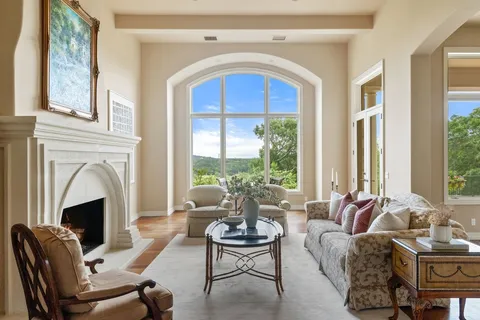 a living room with furniture fireplace and window