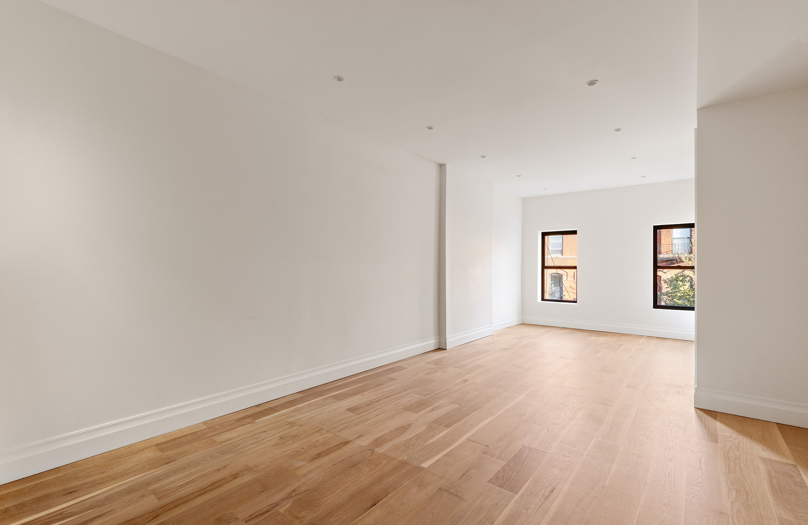 80 7th Avenue, Unit 4 Brooklyn, NY 11217 - Photo 2 of 9 a view of an empty room with a window and wooden floor