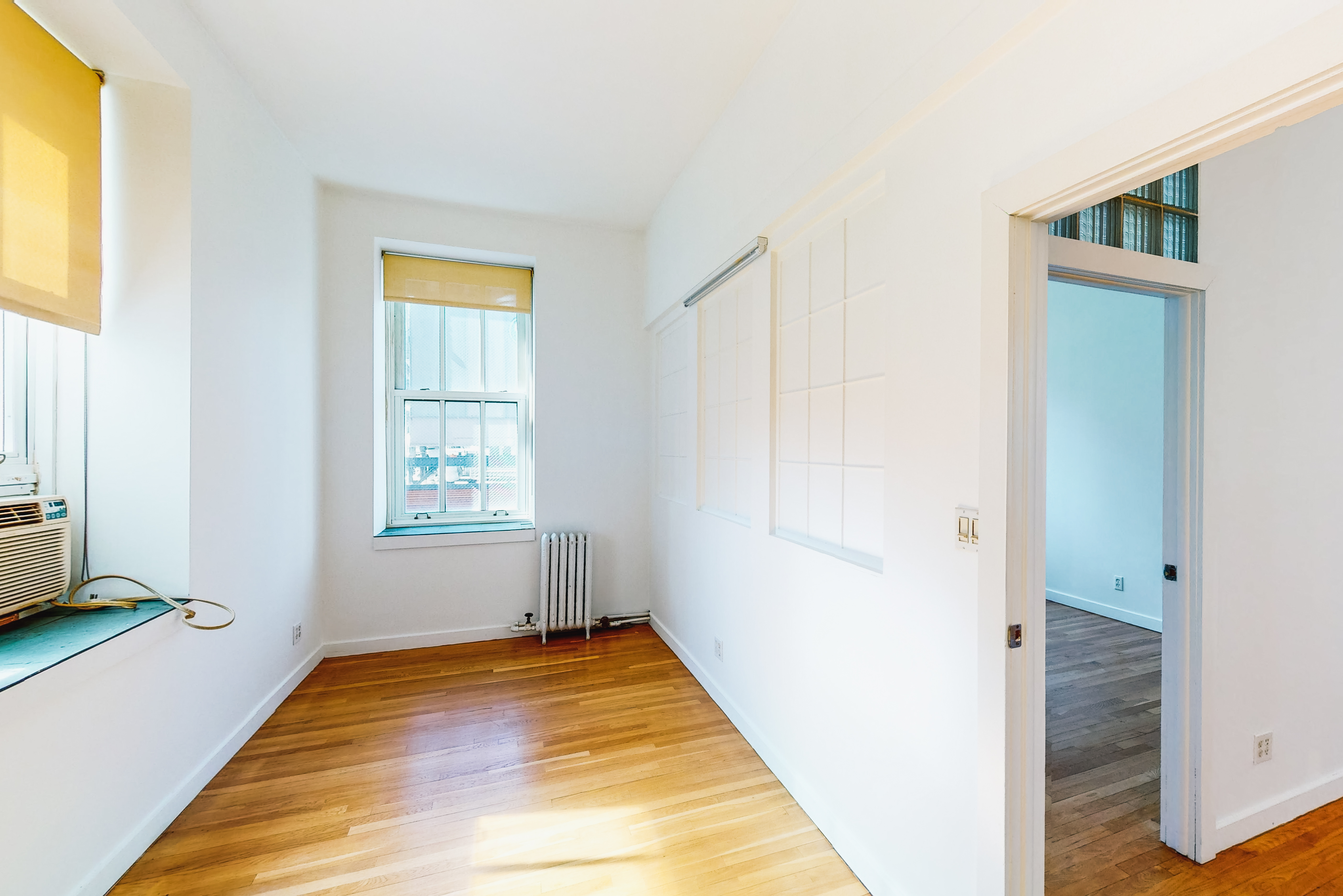 395 Broadway, Unit 7E Manhattan, NY 10013 - Photo 4 of 7 a view of an empty room with a window