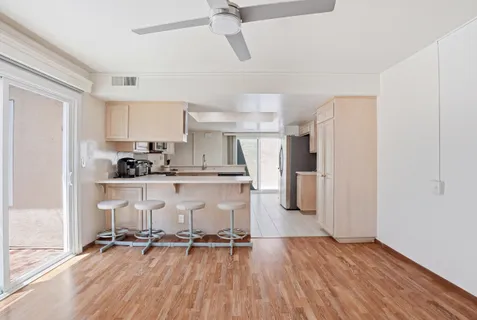 a view of kitchen with refrigerator microwave and stove