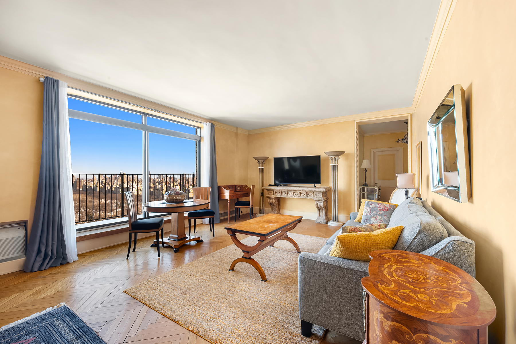 150 Central Park South, Unit 3201 Manhattan, NY 10019 - Photo 1 of 7 a living room with furniture and a flat screen tv