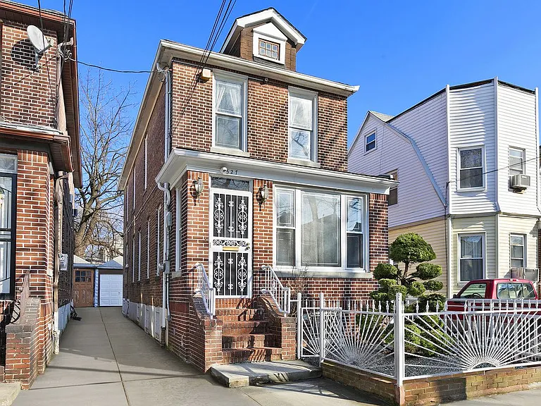 527 East 38th Street Brooklyn, NY 11203 - Photo 13 of 15 front view of a brick house with a porch