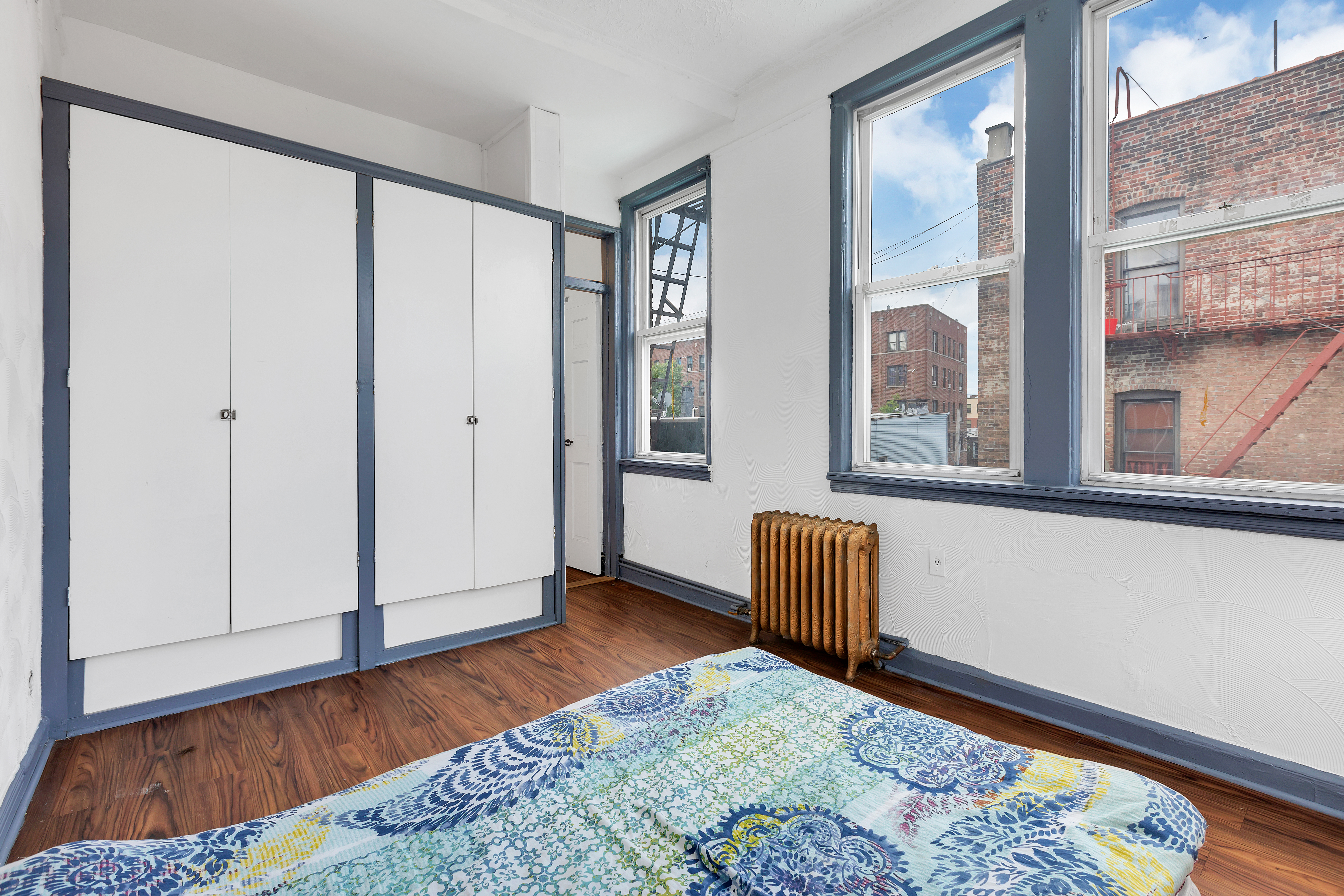 2255 Bathgate Avenue Bronx, NY 10457 - Photo 2 of 14 a view of an empty room and window with wooden floor