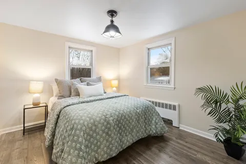 a bed sitting in a bedroom next to a lamp