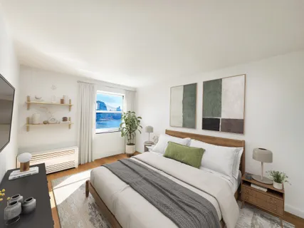 a bedroom with a bed and a large window