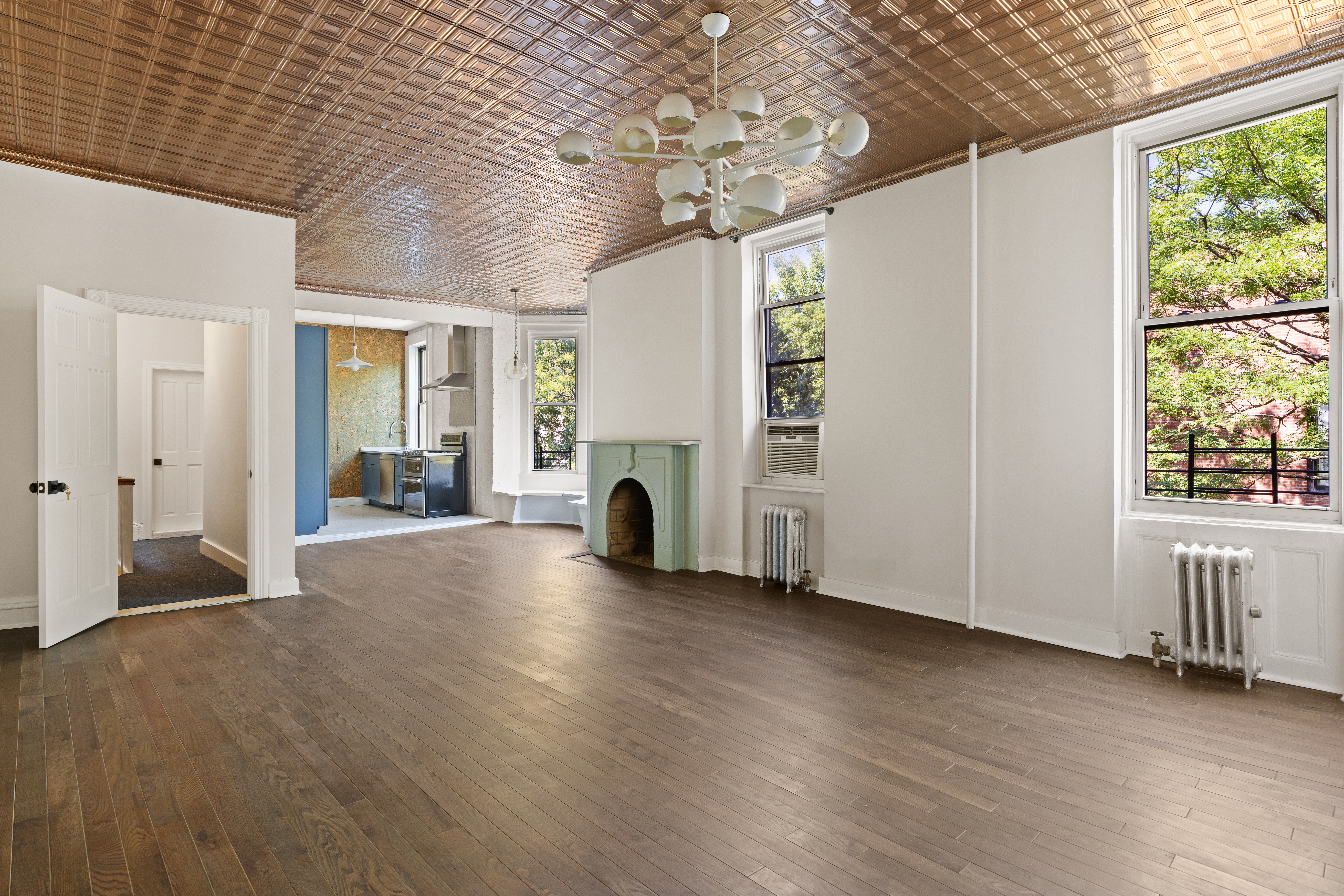 208 Warren Street Brooklyn, NY 11201 - Photo 2 of 10 a view of empty room with wooden floor and fan