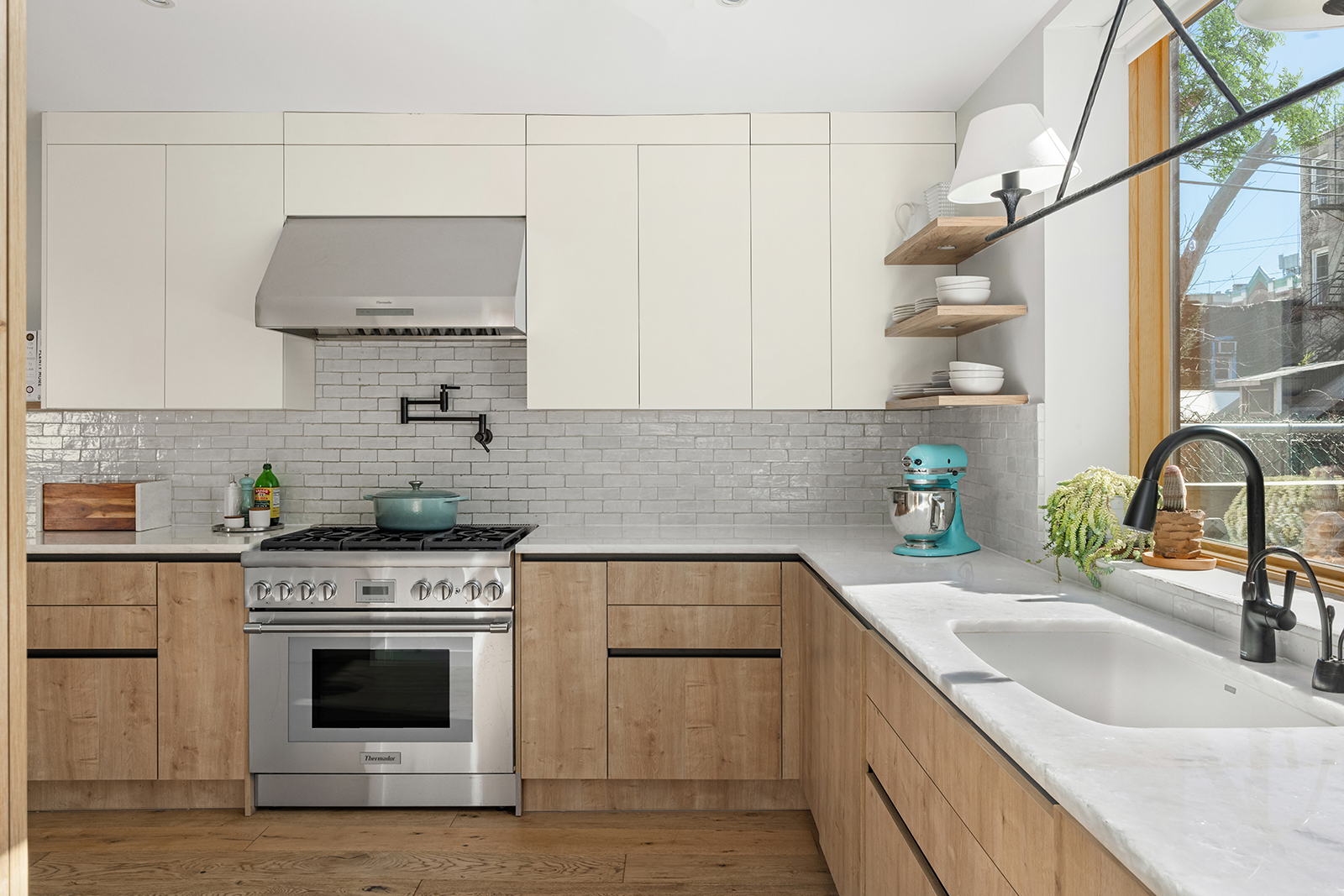 683 Leonard Street Brooklyn, NY 11222 - Photo 5 of 25 a kitchen with stainless steel appliances white cabinets a sink and a stove