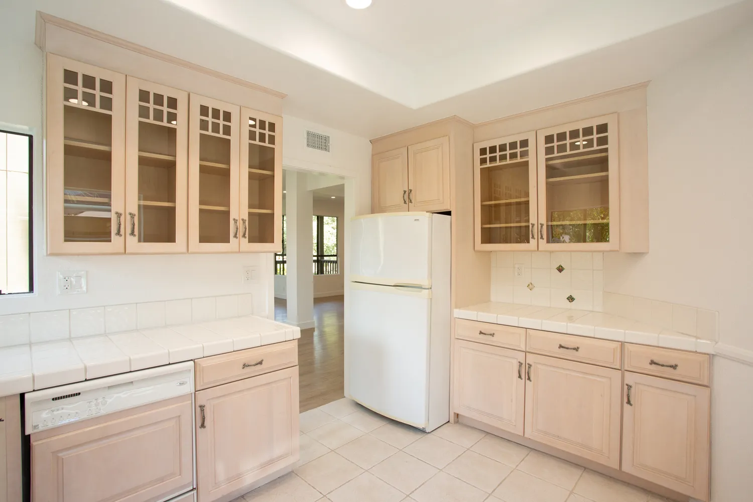 a kitchen with white cabinets and white appliances