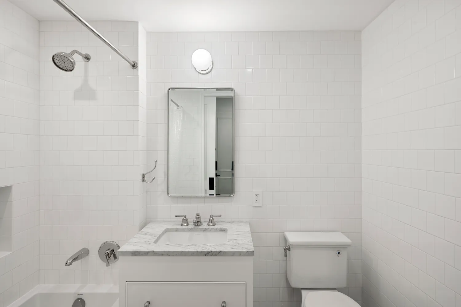 a bathroom with a granite countertop sink mirror and toilet