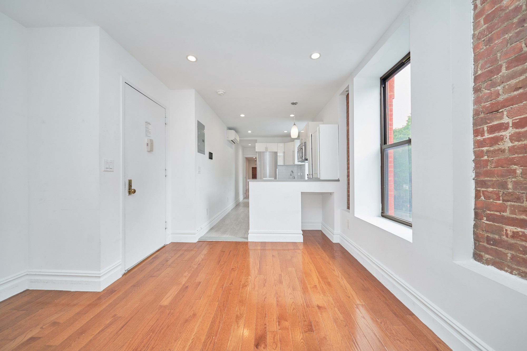 941 Columbus Avenue, Unit 1A Manhattan, NY 10025 - Photo 10 of 14 a view of a kitchen with wooden floor and a window