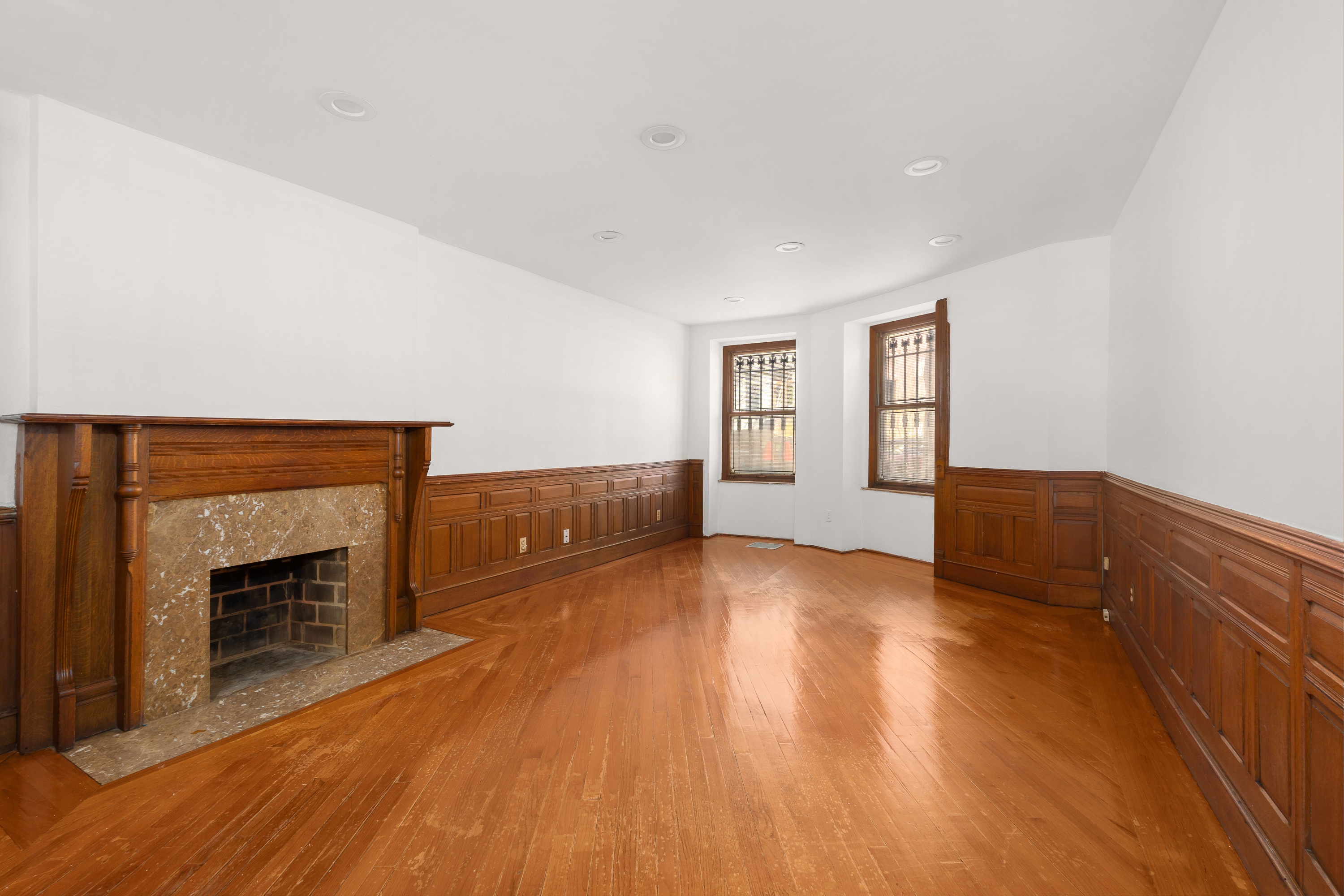 420 8th Street Brooklyn, NY 11215 - Photo 16 of 20 a view of empty room with wooden floor and fireplace