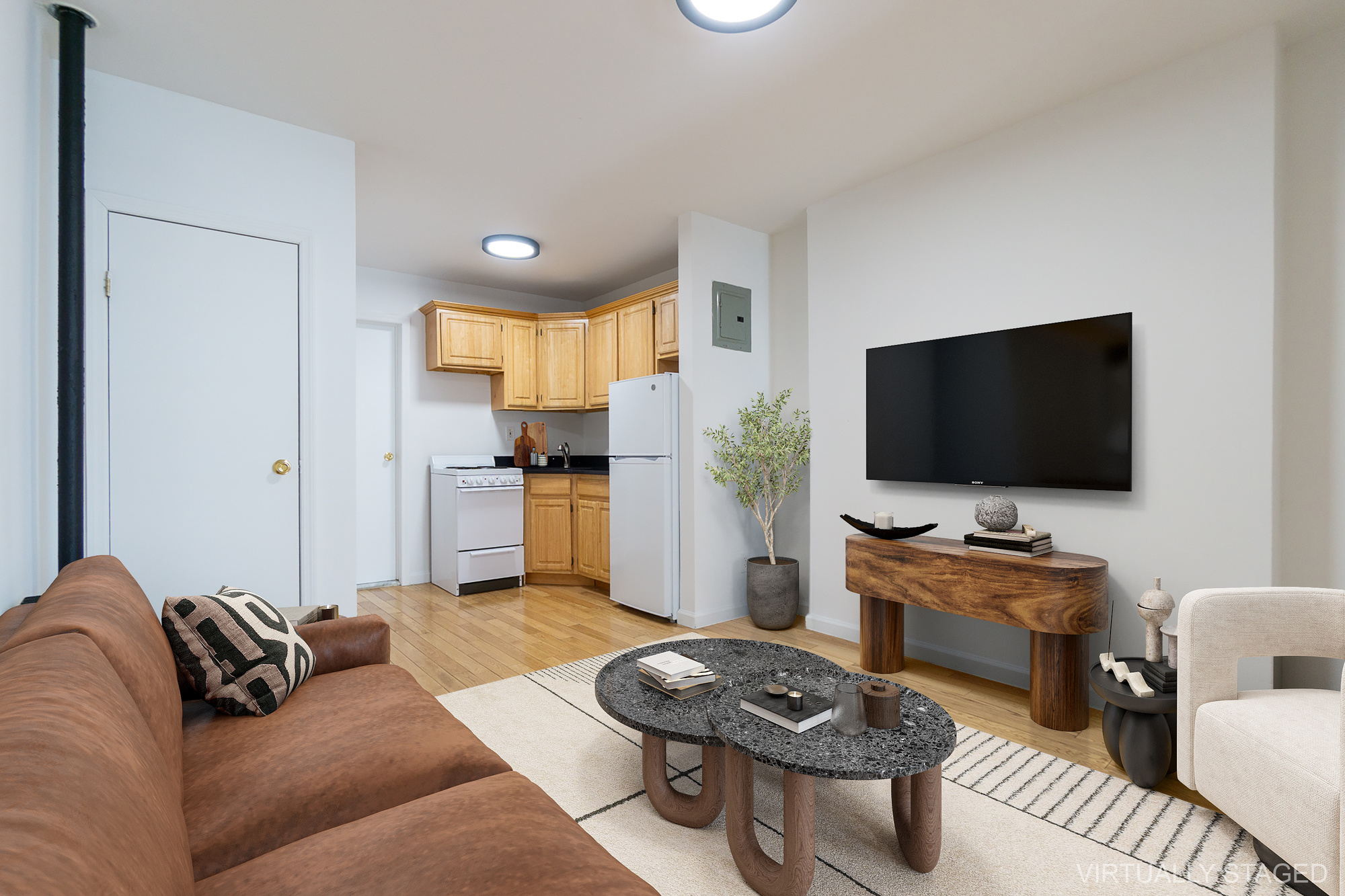 337 East 6th Street, Unit 9 Manhattan, NY 10003 - Photo 7 of 15 a living room with furniture and a flat screen tv