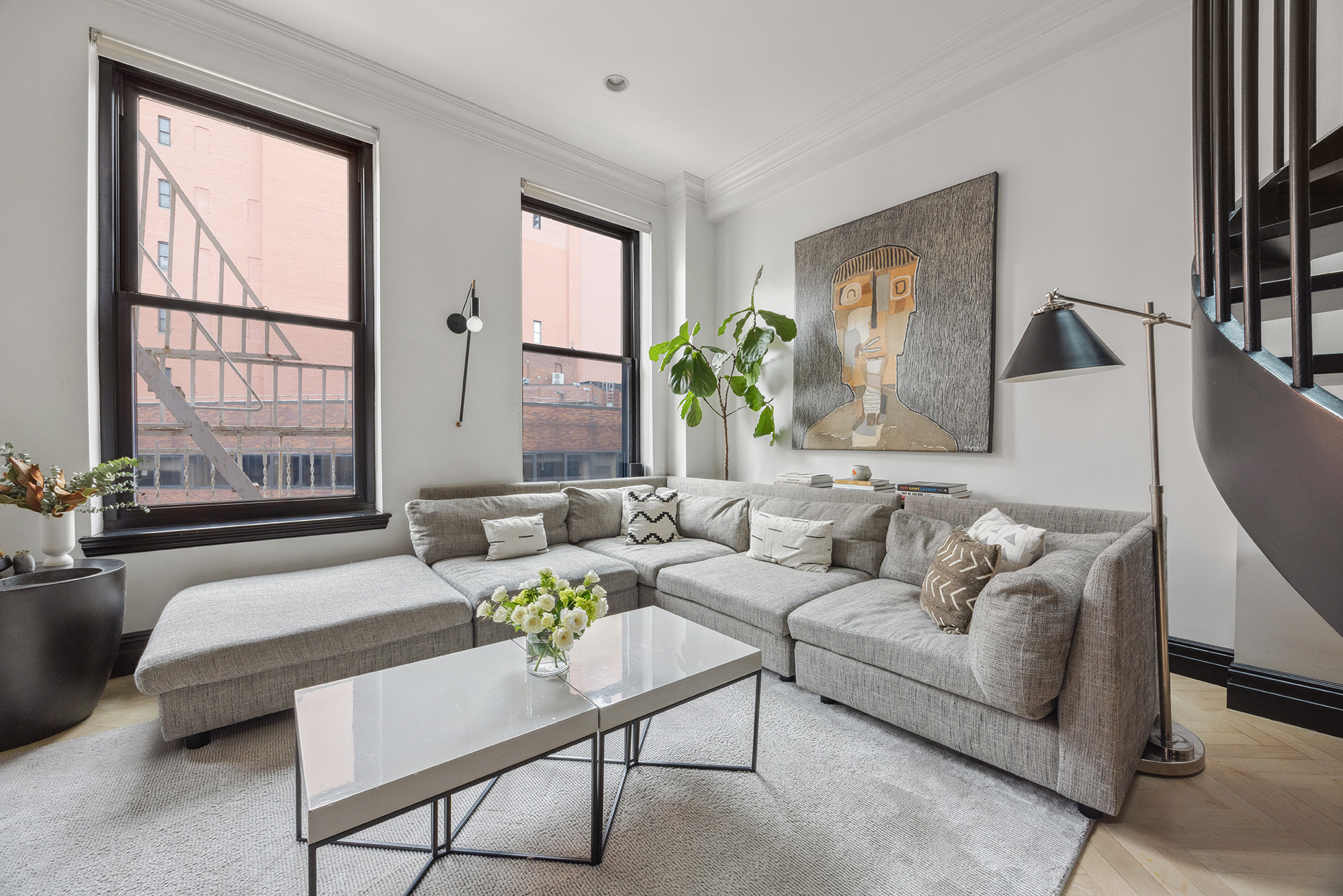 250 Mercer Street, Unit A504 Manhattan, NY 10012 - Photo 4 of 13 a living room with furniture and a large window