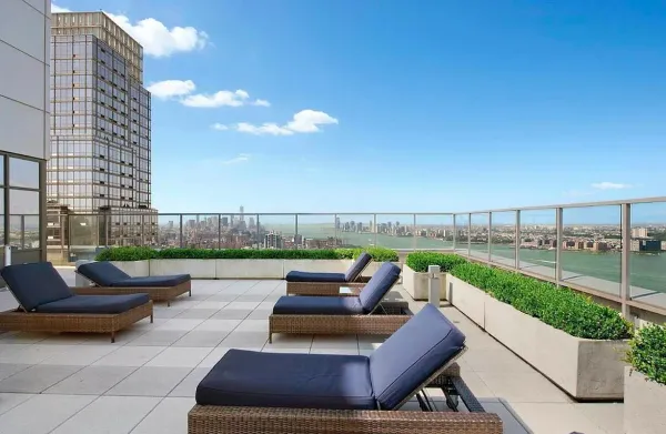 a view of a terrace with couches and lounge chairs