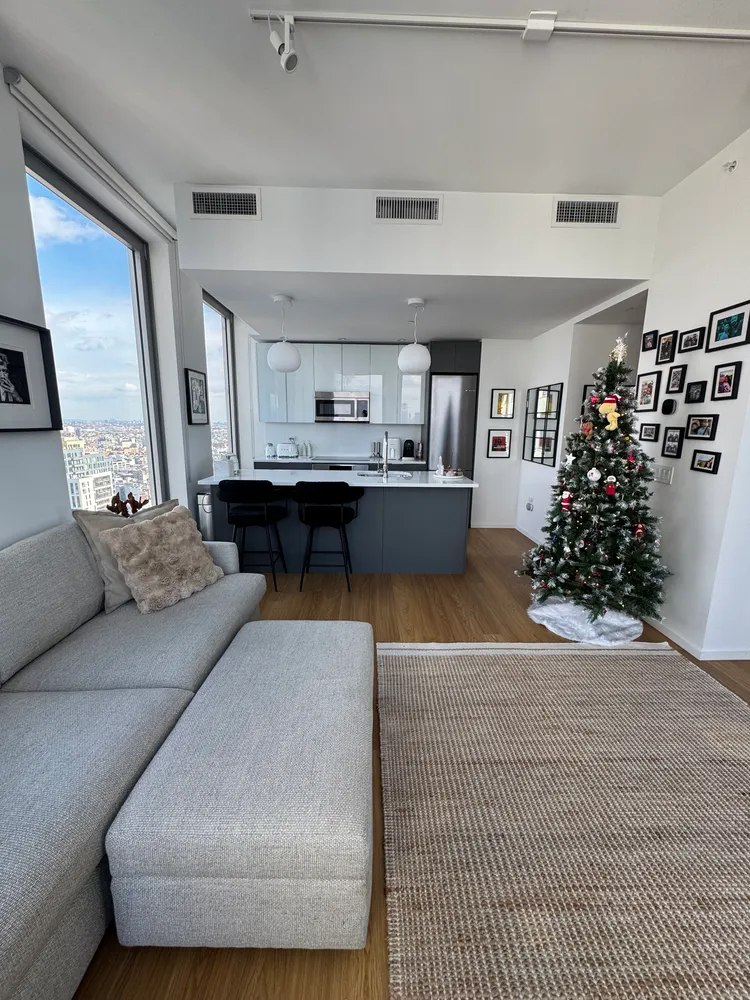 a living room with furniture and flowers