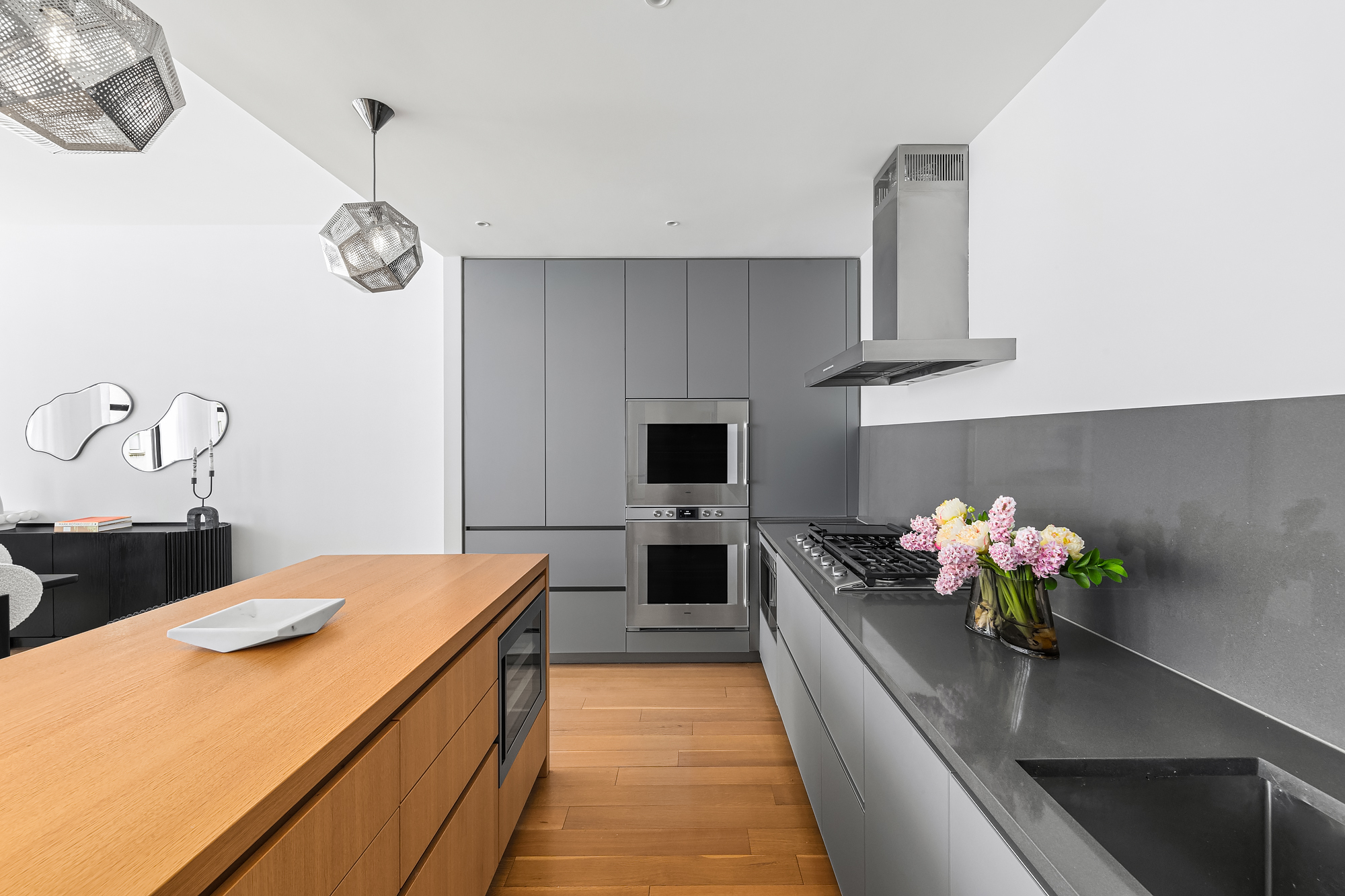 71 Reade Street, Unit 4D Manhattan, NY 10007 - Photo 6 of 15 a kitchen with stainless steel appliances a stove refrigerator and a chandelier