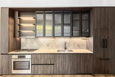 a kitchen with a sink and cabinets