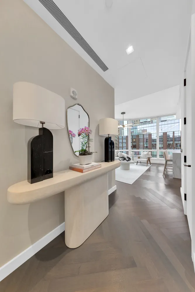 a living room with furniture and a mirror