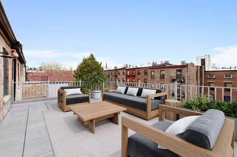 a bedroom with a bed a couch and a window