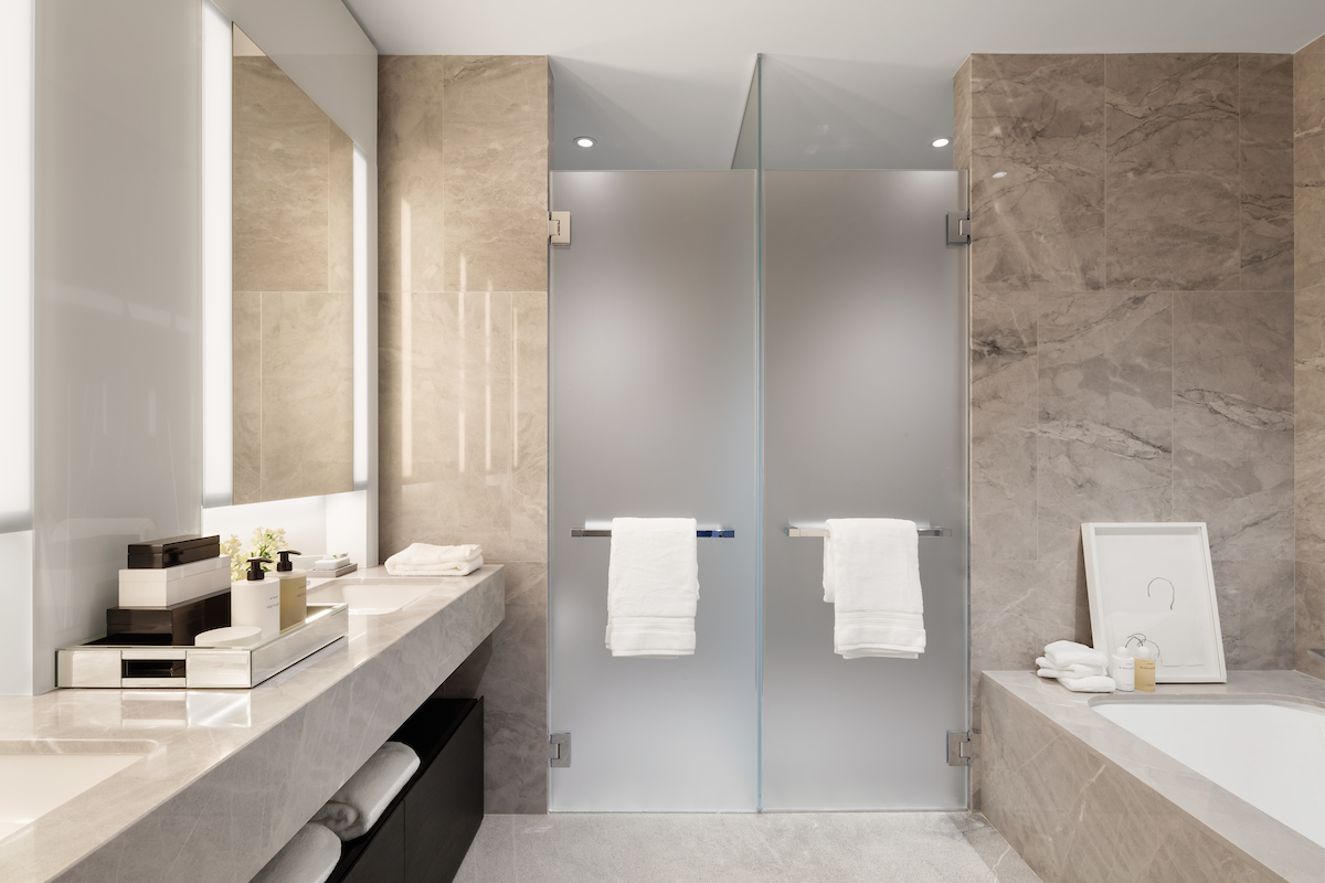 15 Hudson Yards, Unit 77B Manhattan, NY 10001 - Photo 6 of 24 a bathroom with a double vanity sink toilet and mirror