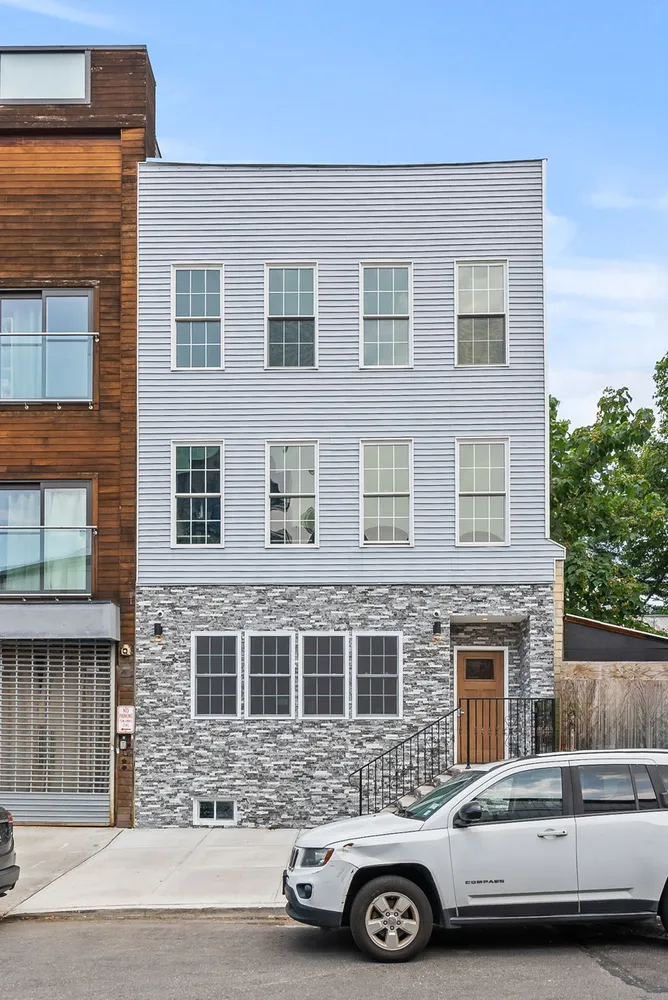 a front view of a house with parking space