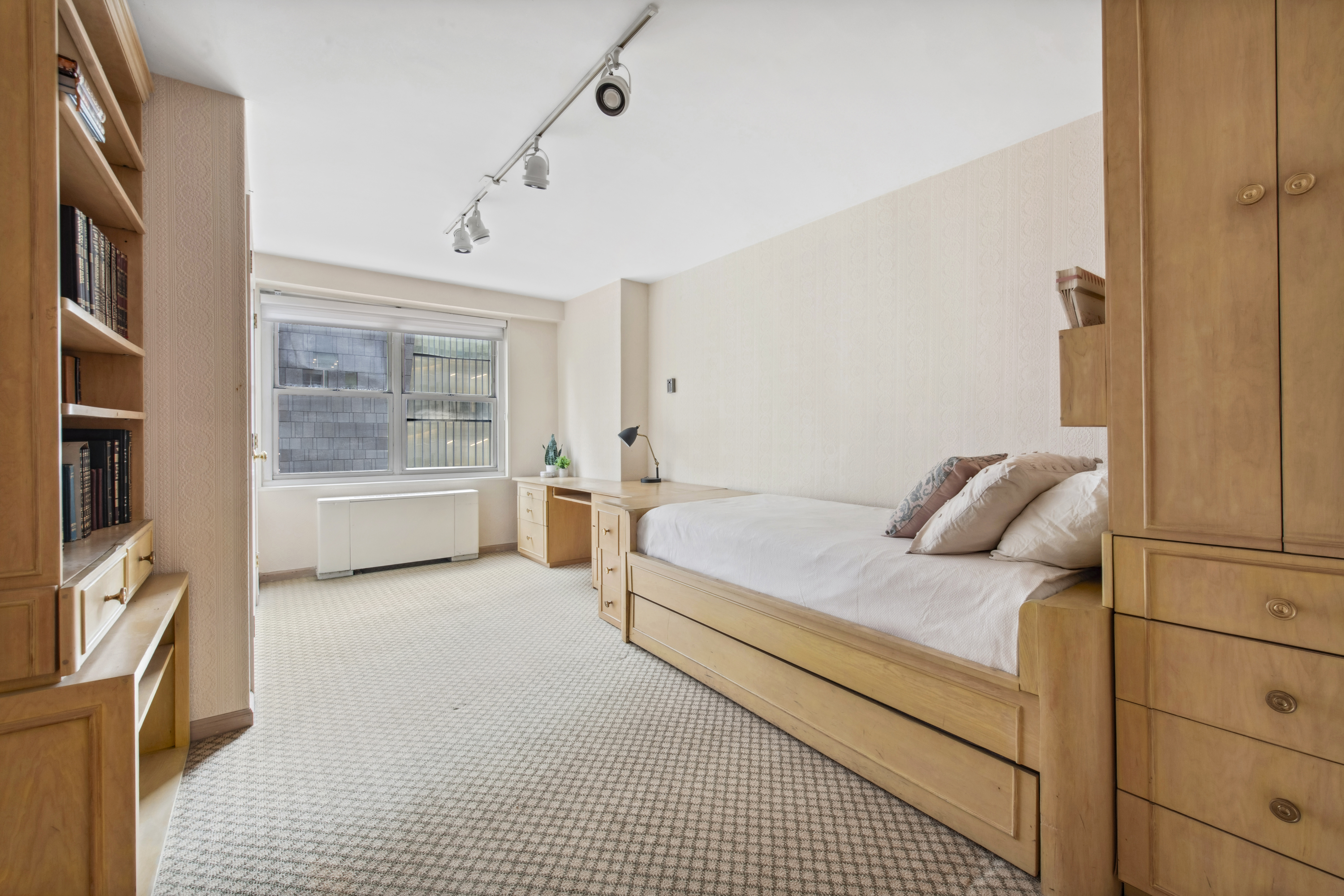 155 West 68th Street, Unit 404 Manhattan, NY 10023 - Photo 12 of 21 a bedroom with a bed and a large window