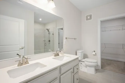 a bathroom with a sink toilet and a mirror