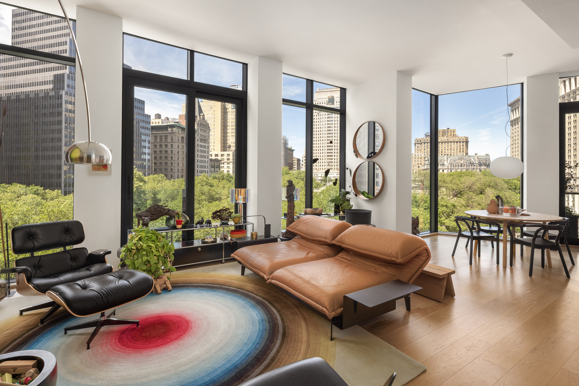 33 Park Row, Unit 6B Manhattan, NY 10038 - Photo 3 of 24 a living room with furniture and floor to ceiling windows