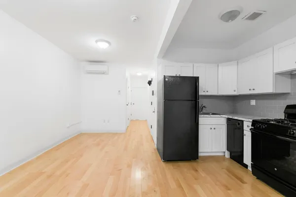 a kitchen with a refrigerator and a stove