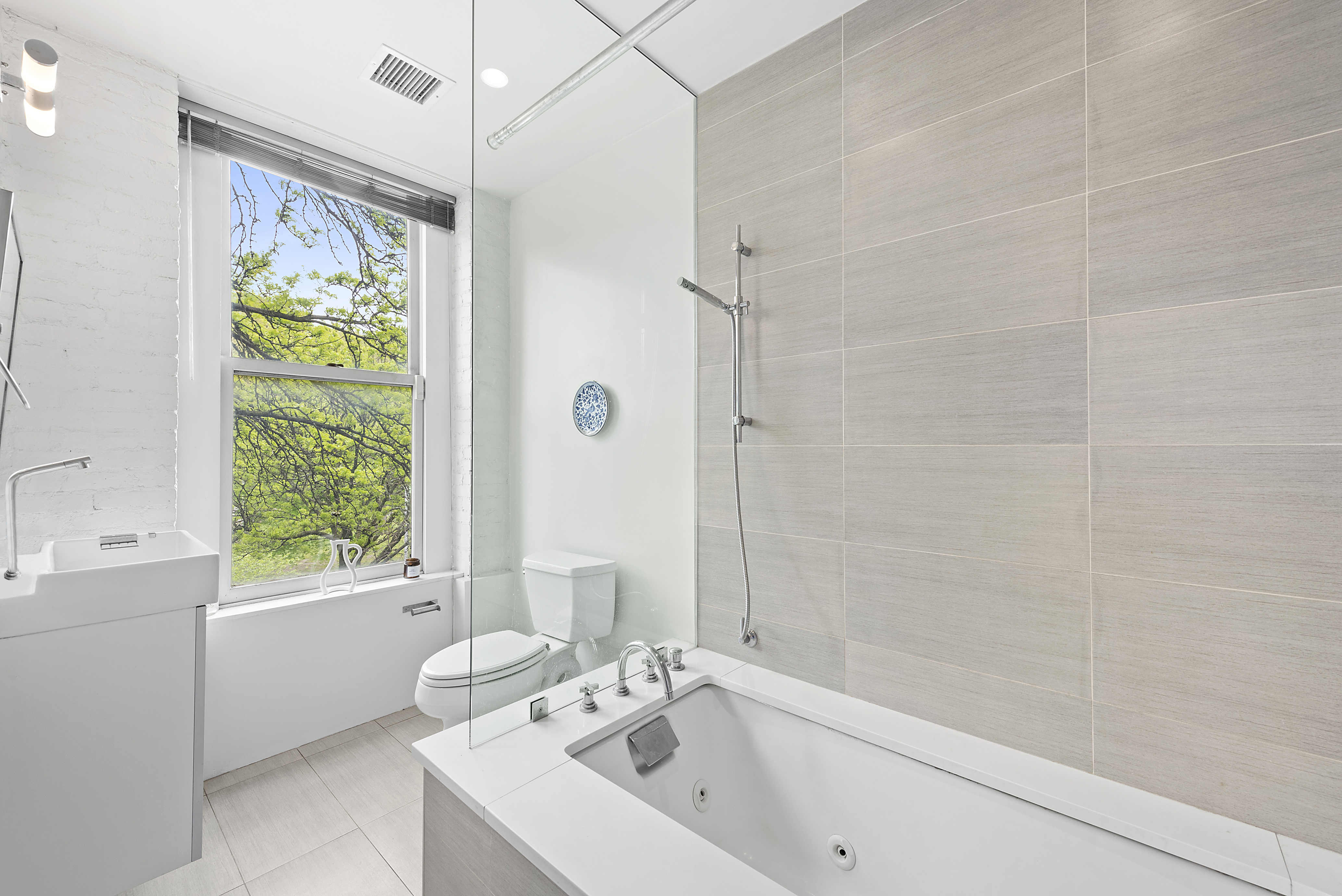 22 West 120th Street Manhattan, NY 10027 - Photo 9 of 21 a bathroom with a sink a bathtub and shower