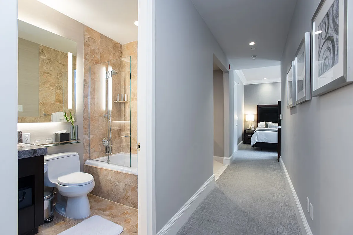 1 Central Park West, Unit 612 Manhattan, NY 10023 - Photo 6 of 13 a en suite bathroom with a toilet a sink and a large mirror