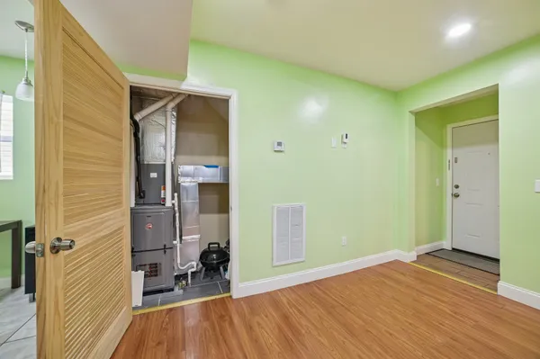 a view of a room with wooden floor and a bathroom