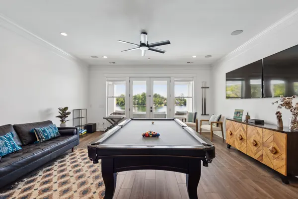 a living room with furniture a rug and a flat screen tv