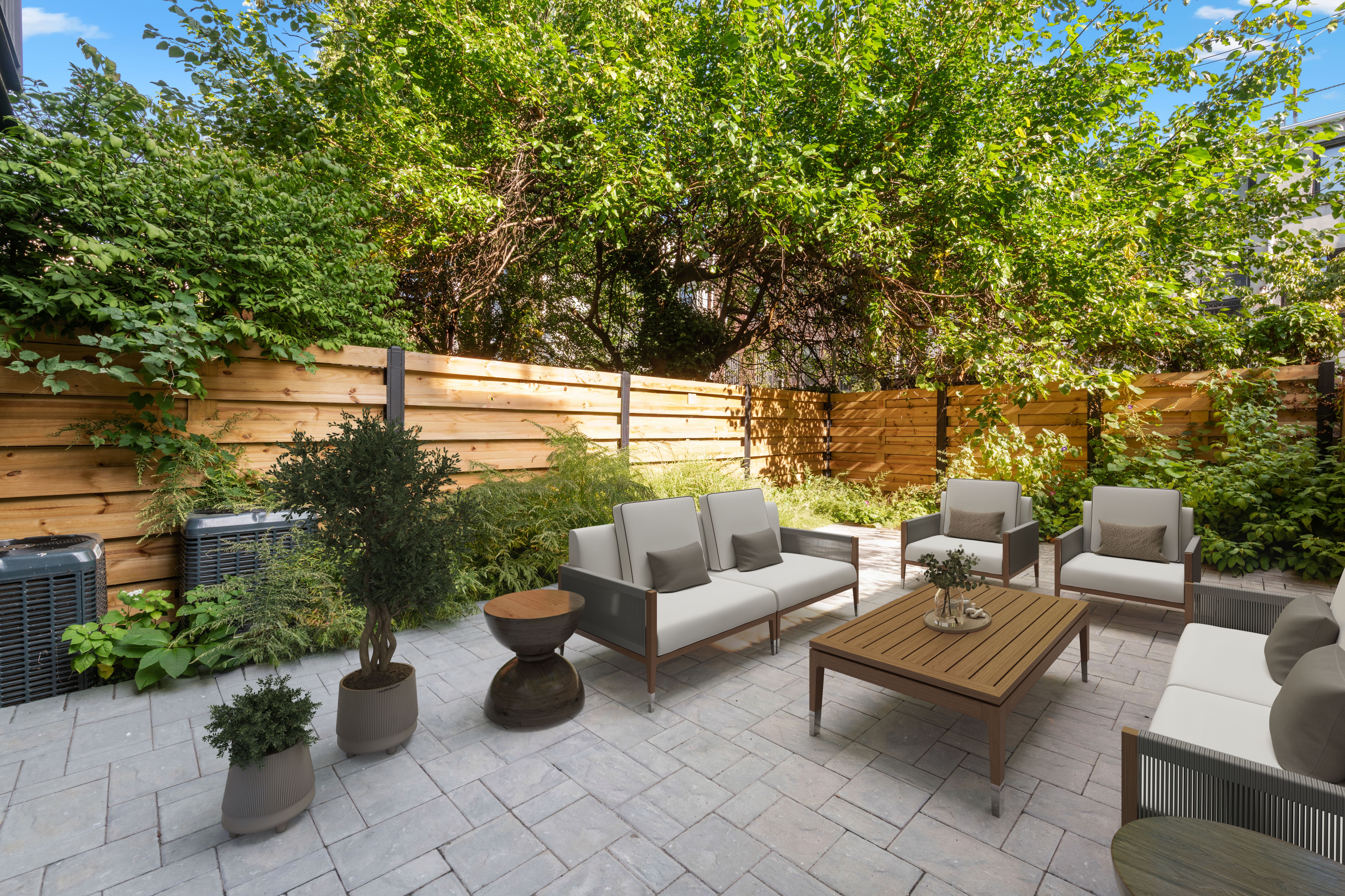129 West 131st Street, Unit 1 Manhattan, NY 10027 - Photo 8 of 15 a view of a patio with couches and potted plants