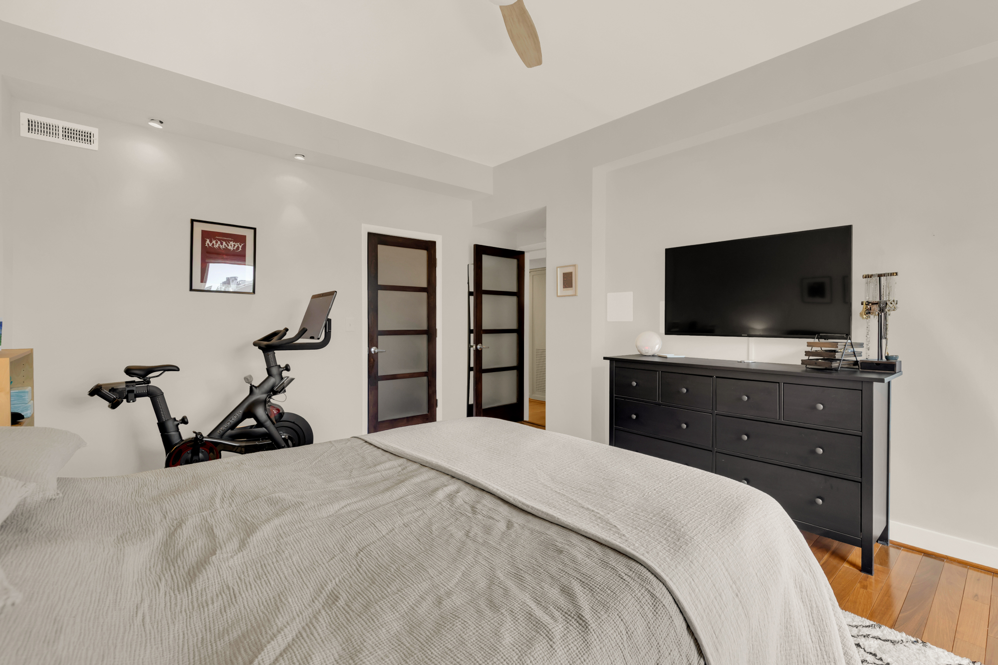 2127 California Street Northwest, Unit 505 Washington, DC 20008 - Photo 29 of 40 a bedroom with a bed and a flat tv screen on dresser