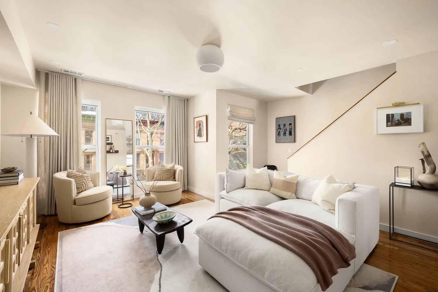 a bedroom with furniture and a large window