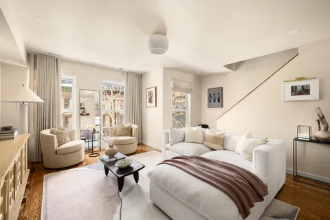 a bedroom with furniture and a large window