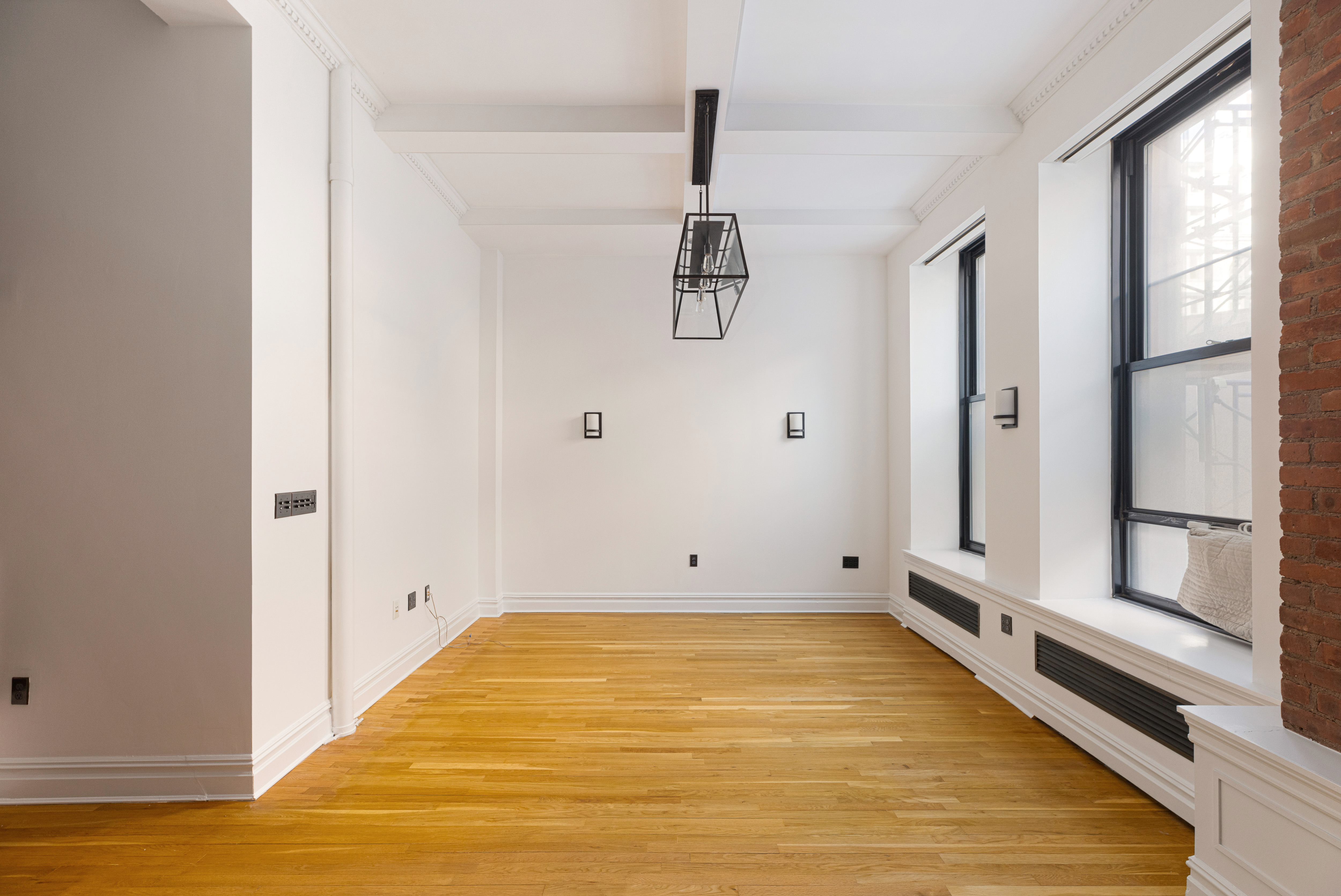 250 Mercer Street, Unit B203 Manhattan, NY 10012 - Photo 11 of 19 a view of a room with wooden floor and white walls