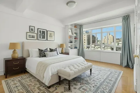 a bedroom with a large bed and a window