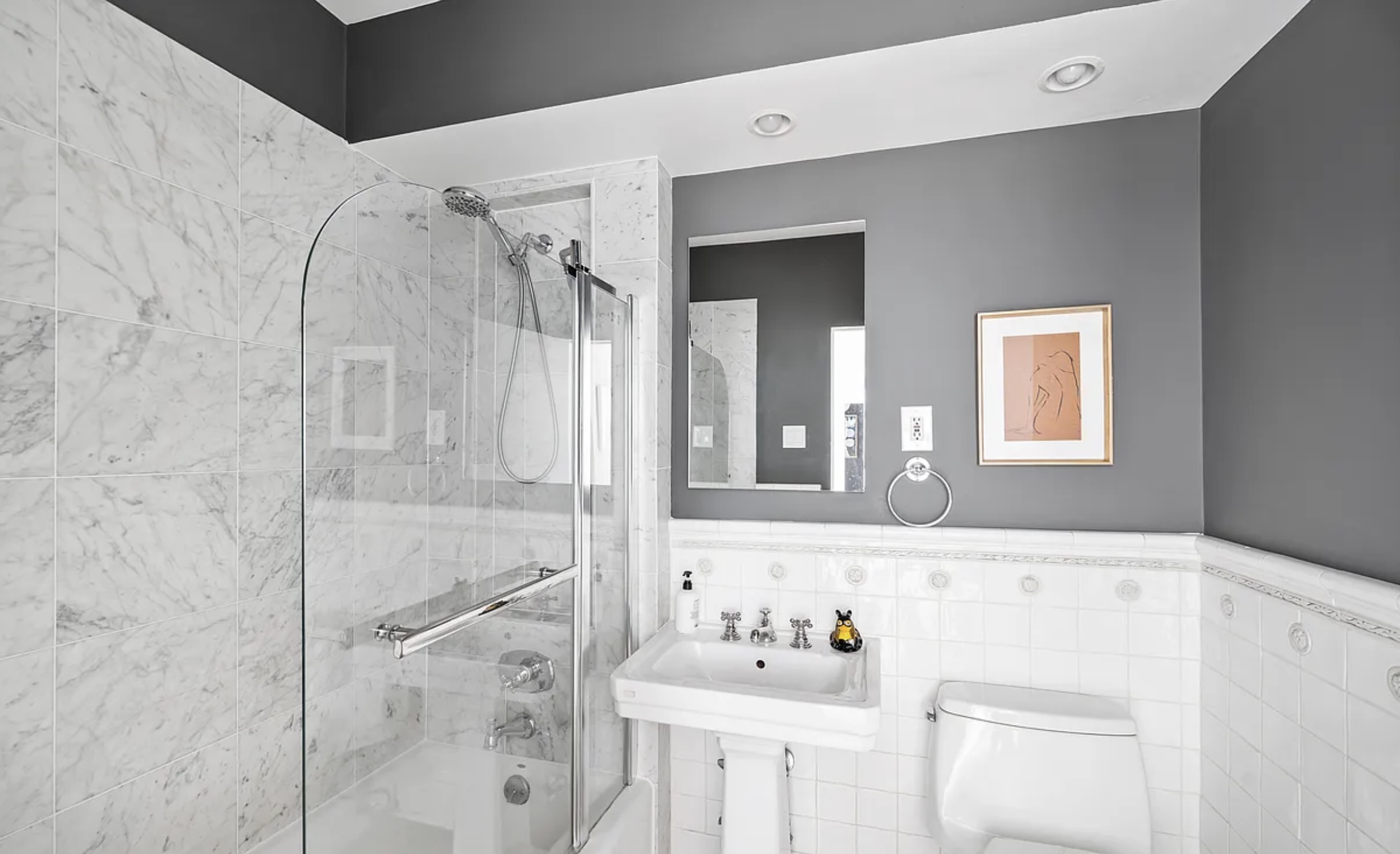 130 East 63rd Street, Unit 3D Manhattan, NY 10065 - Photo 7 of 13 a bathroom with a bathtub sink and mirror